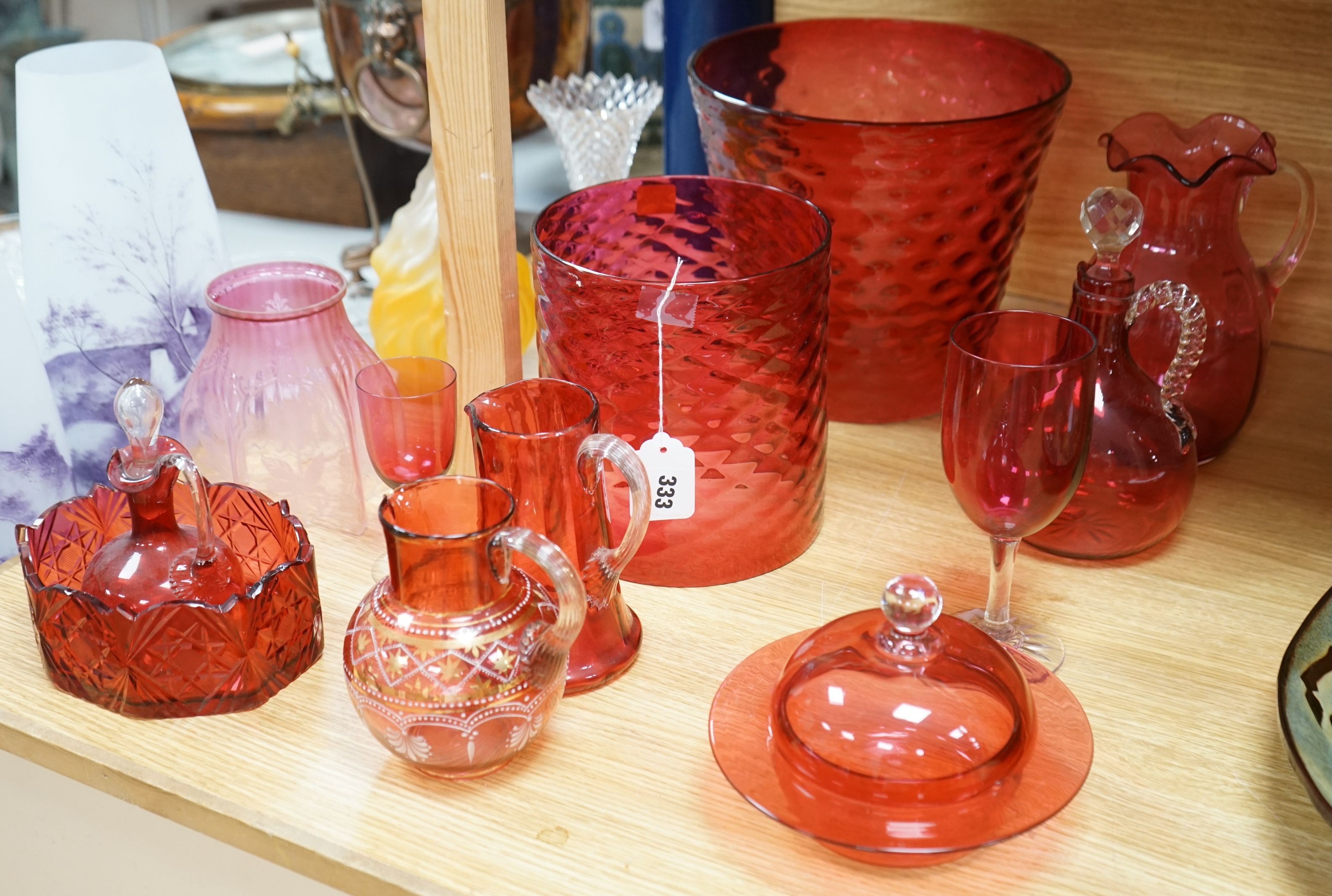Three cranberry glass shades together with mixed cranberry and other glass, tallest shade 23cms high